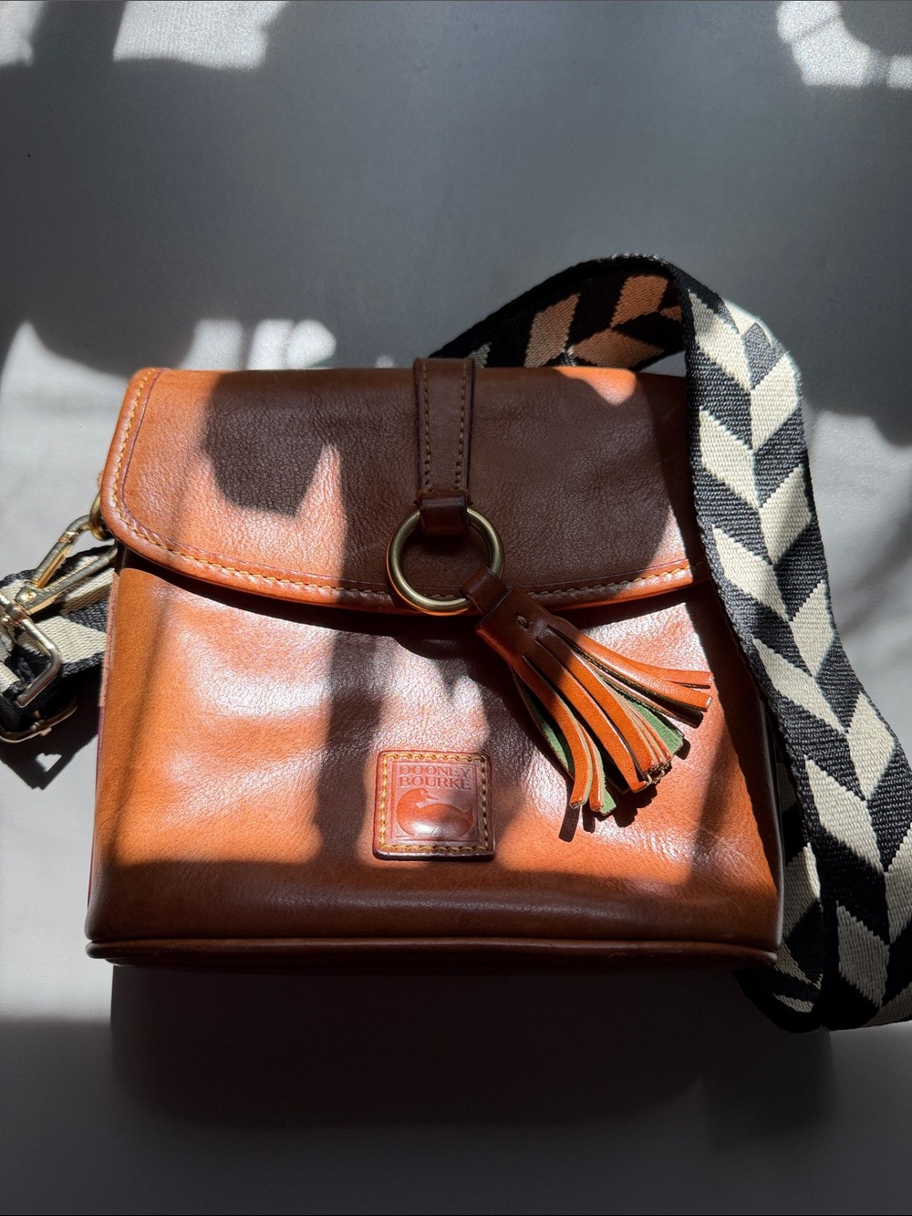 Dooney & Bourke Tan Leather Crossbody with Tassel and Patterned Strap